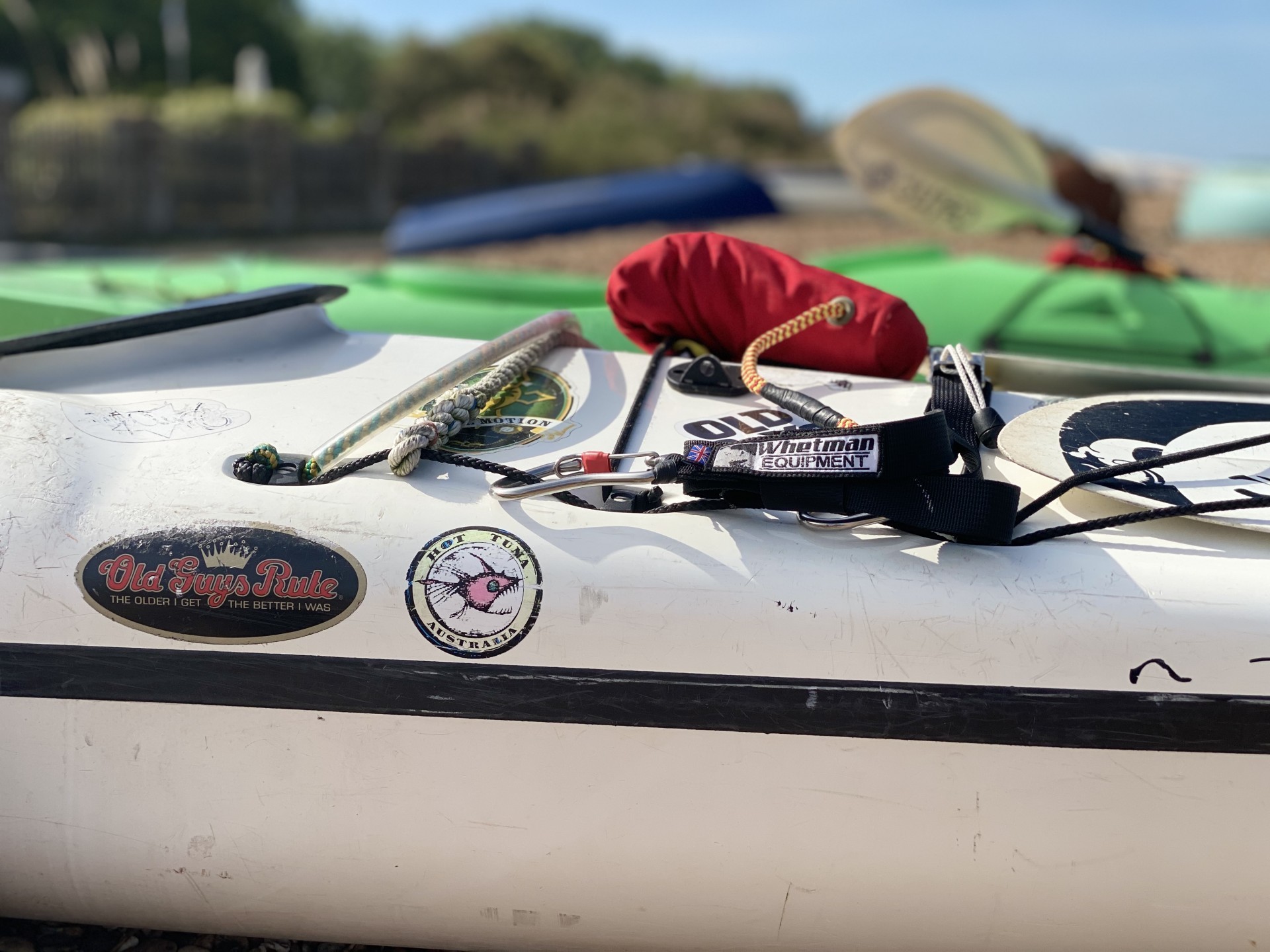 Safety equipment shown on the front deck of a sea kayak ready for a training course
