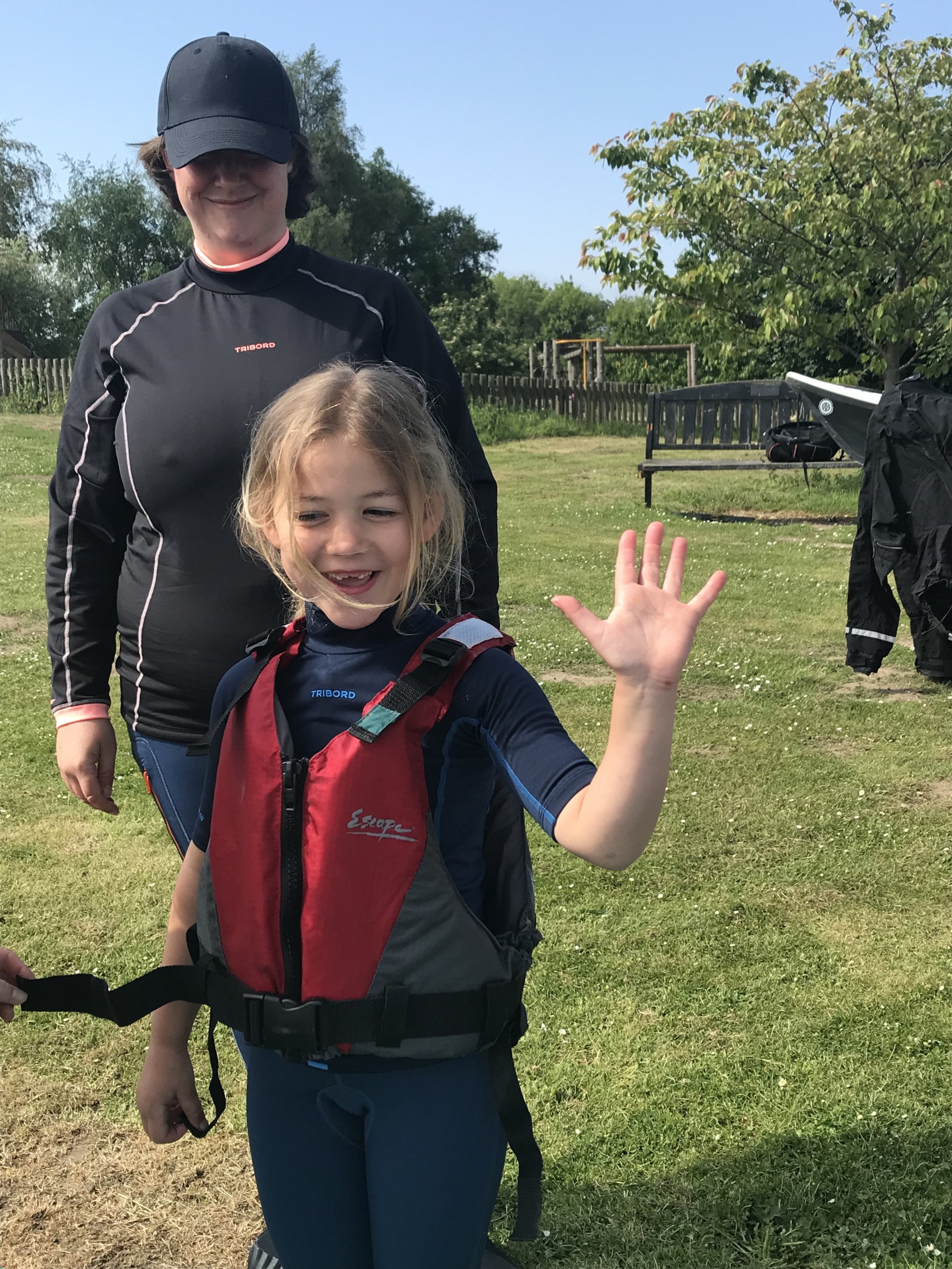 Little girl waves to the camera on a family event kayaking taster session