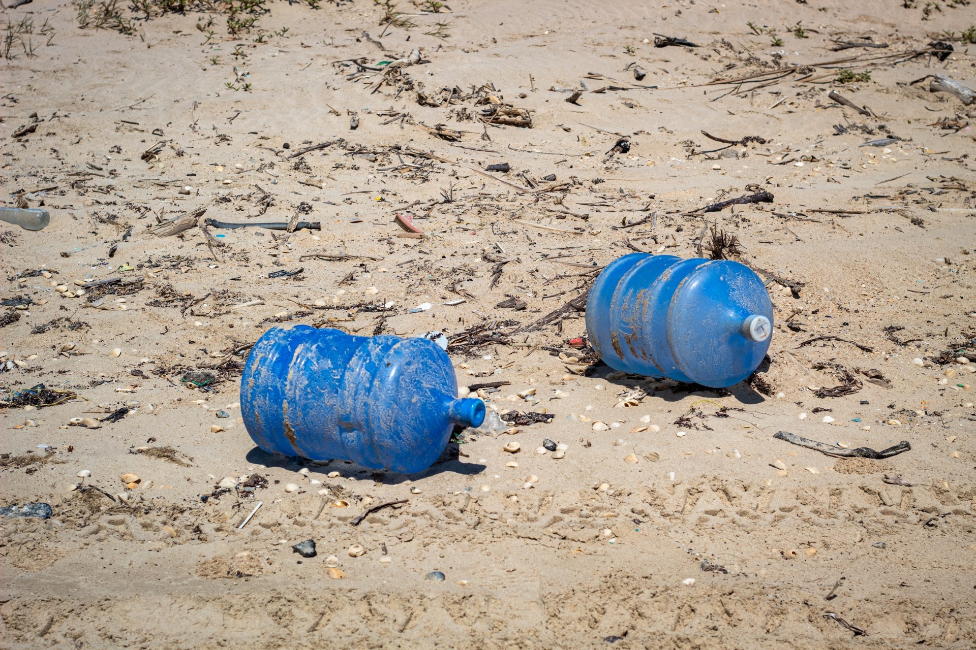 Large water carriers thrown into the sea and washed up on the beach