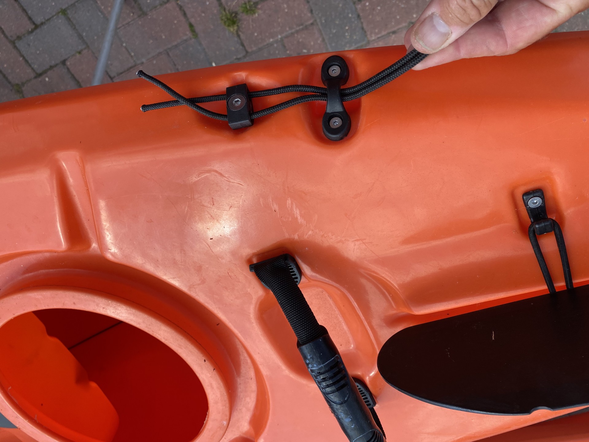 Sit-on-top kayak rudder engagement cable through deck guides.