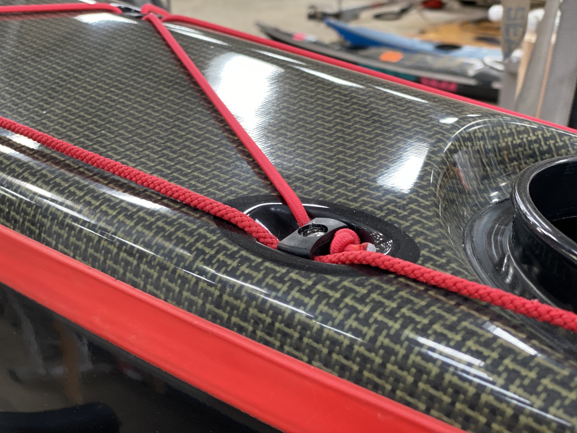 Explorer expedition fibreglass and carbon sea kayak with black hull and red trim