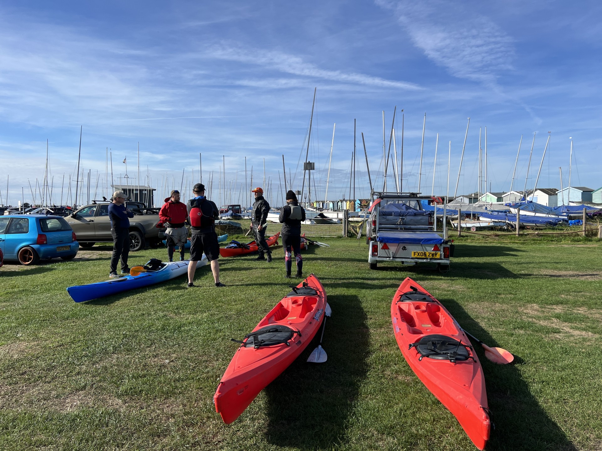 Kayaks on the grass ready for use with NOMAD Sea Kayaking.