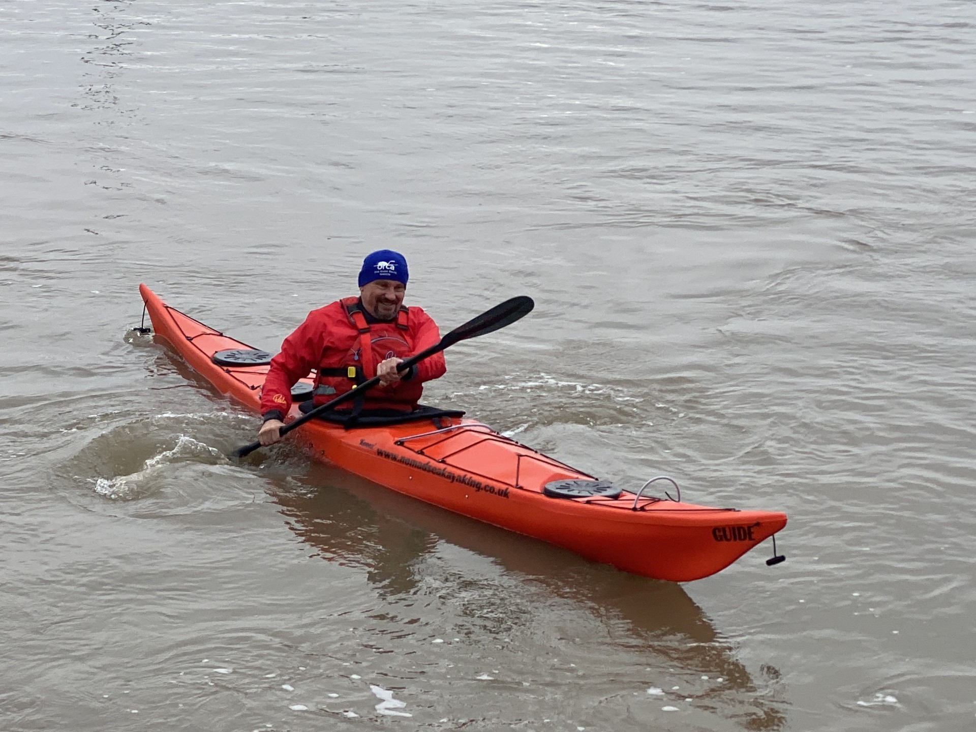 Orange NDK sea kayak on the water.