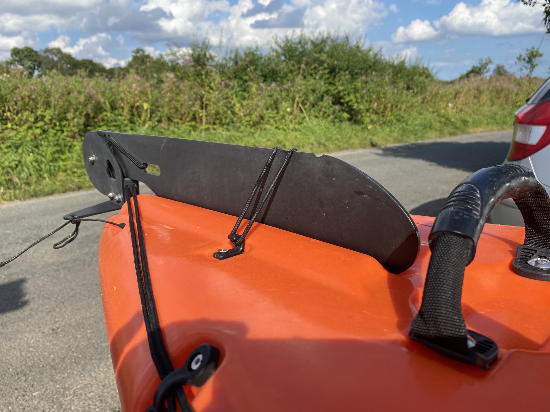 Rudder system on an orange sea kayak with NOMAD Sea Kayaking.