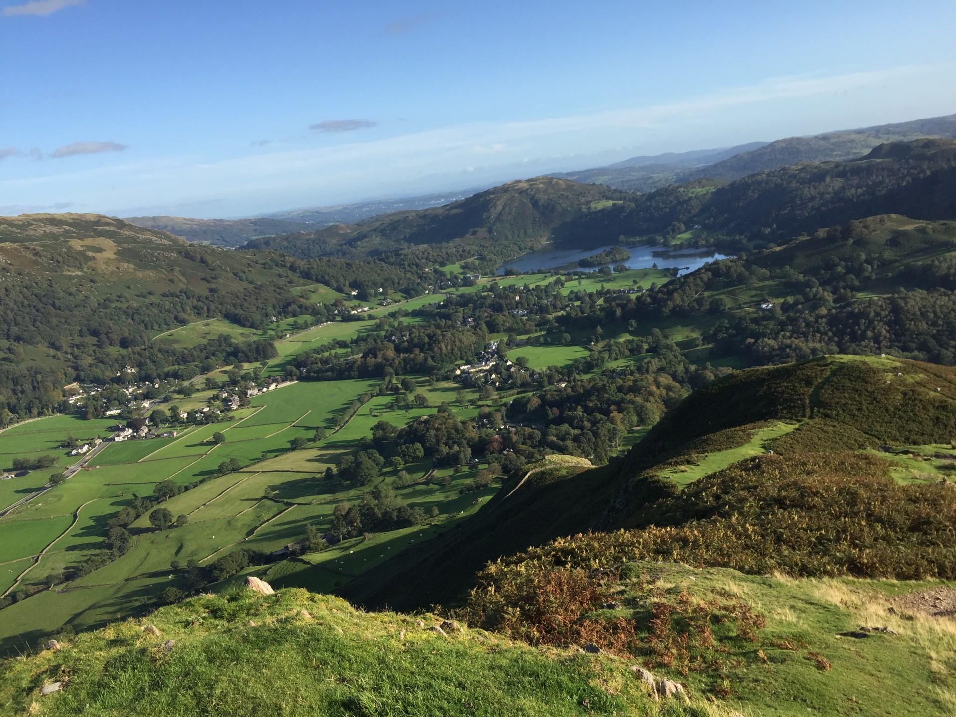 Guided hiking and wild camping trips in the Lake District approaching Grassmere on a sunny day