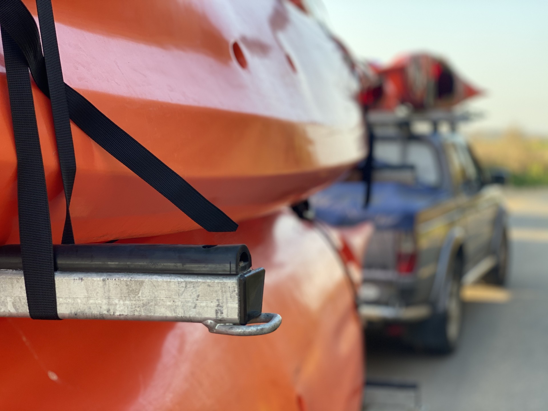 Orange sea kayaks on a trailer.