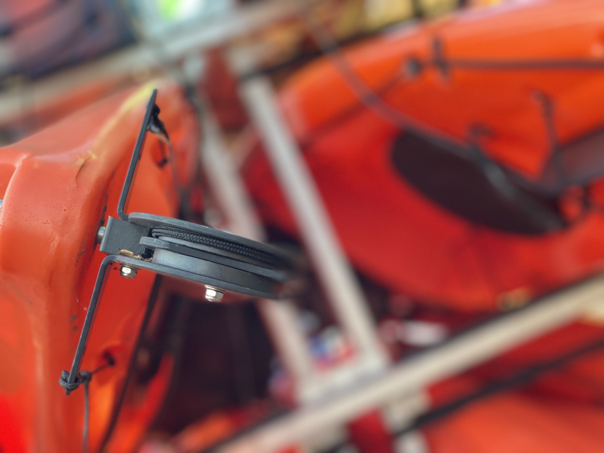 Rudder on the stern of an orange kayak.