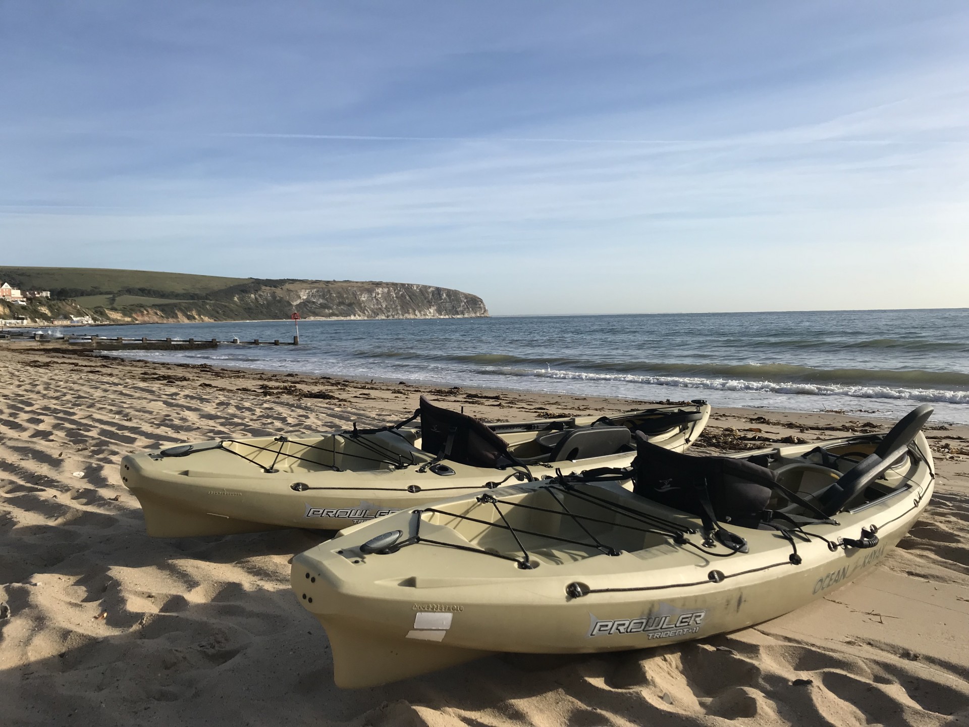 Two Ocean Kayak Prowler sit-on-top kayaks on a sandy beach in Swanage.