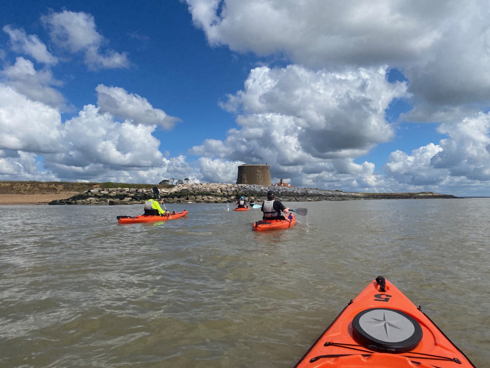 Kayakers on the water on a beginner kayaking and wild camping trip in Suffolk