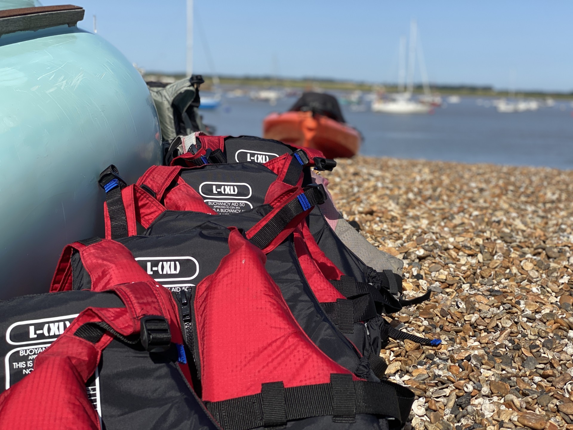 Red buoyancy aids lined up ready for use.
