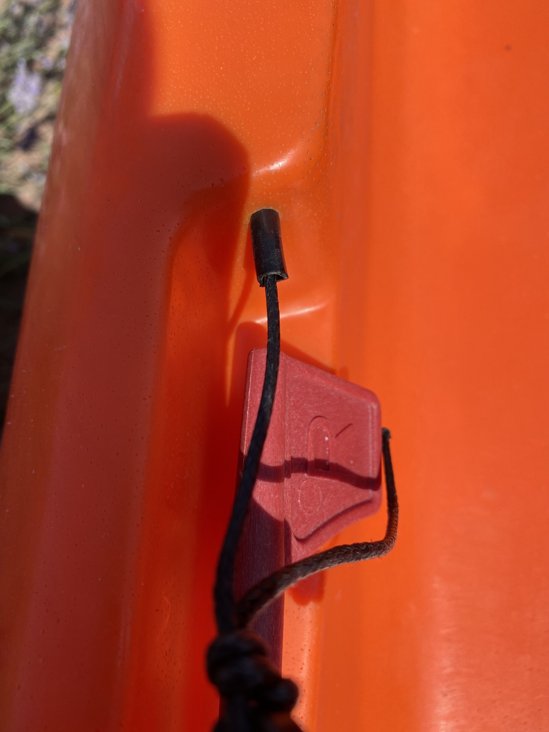 Sit-on-top kayak rudder entry point of steering cable to stern of boat.