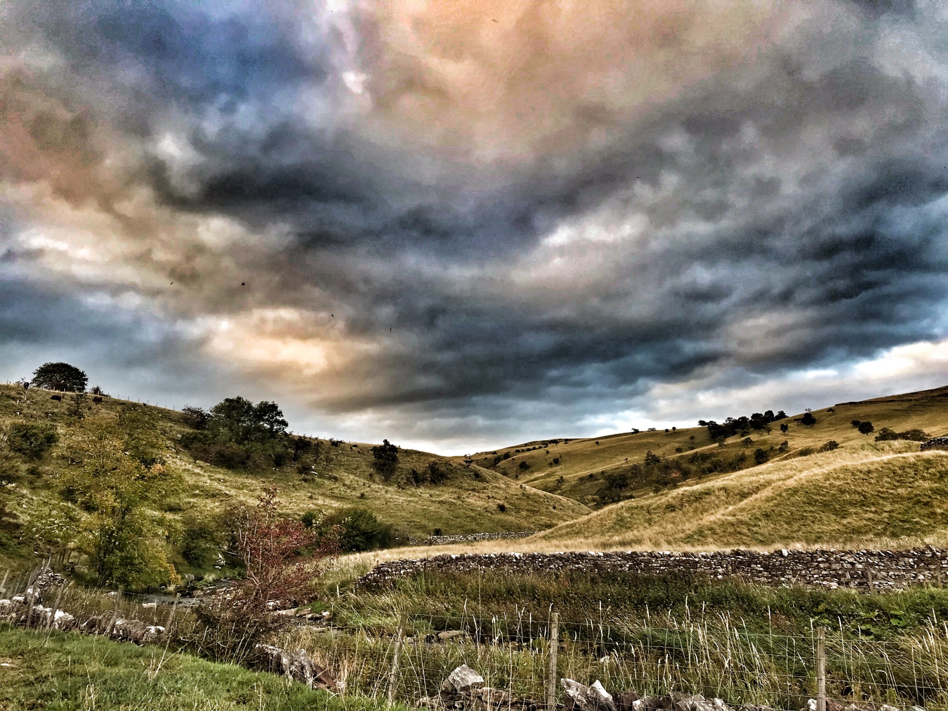 Open hills with a stream lake district hiking trips.