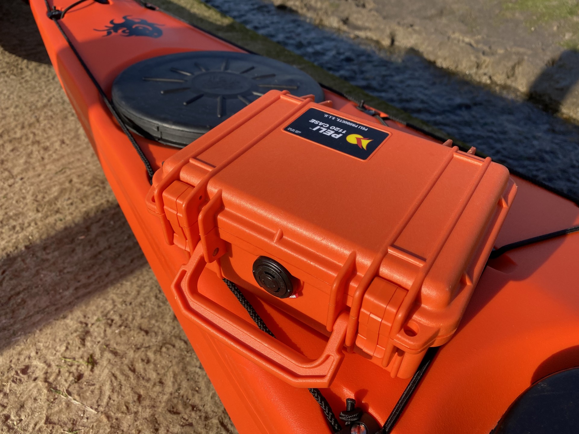 Peli waterproof & rustproof case in orange on a matching sea kayak.