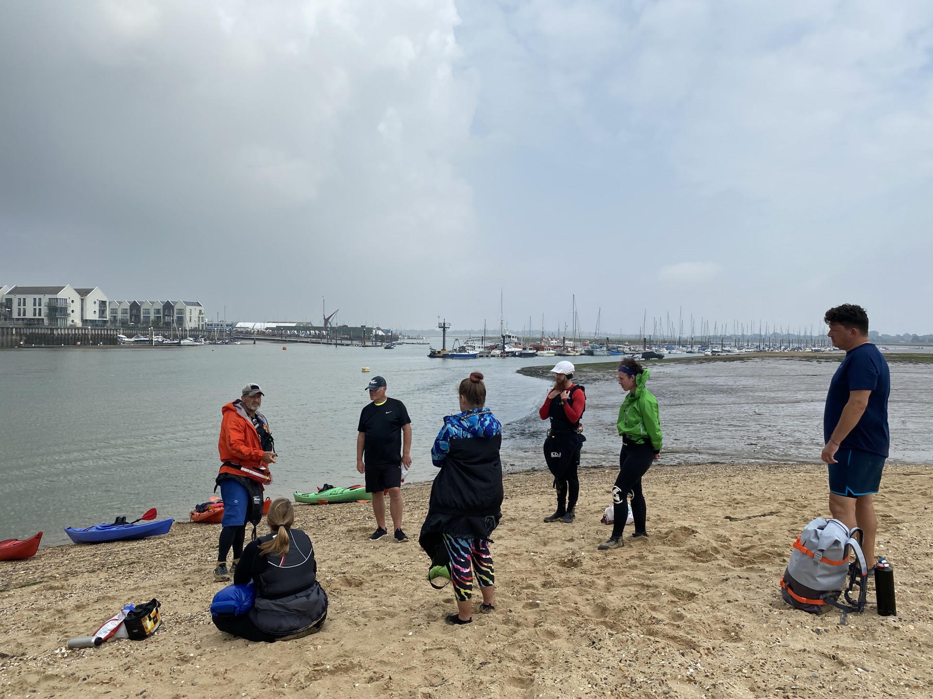 A group being briefed on a beach during the introduction to sea kayaking courseOrganised beach clean events by kayak.