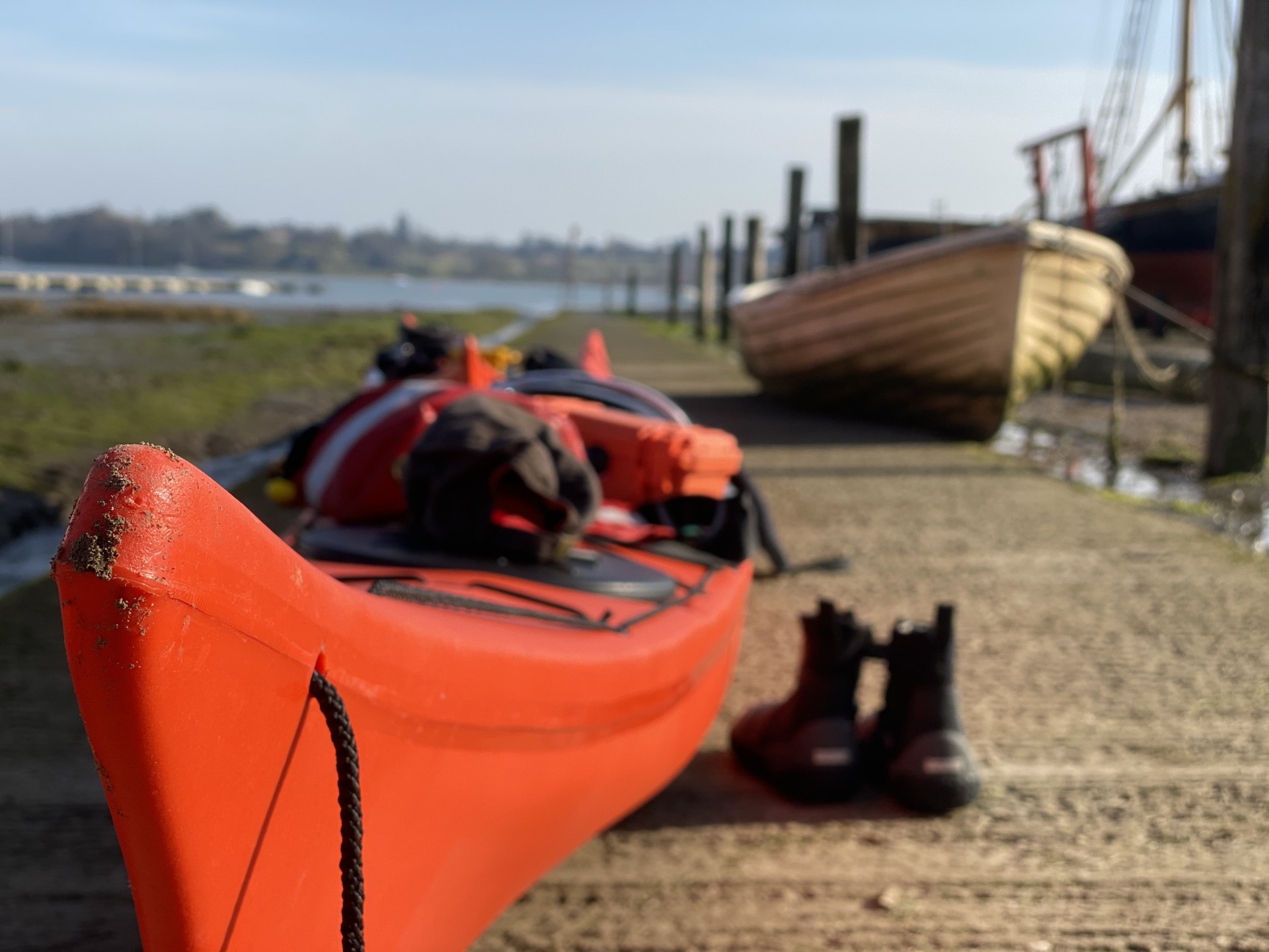 An orange sea kayak on the slipway ready to launch.