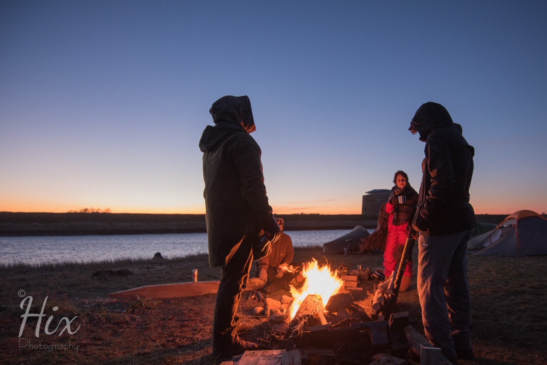 Warm around the fire at sunset on a wild camp