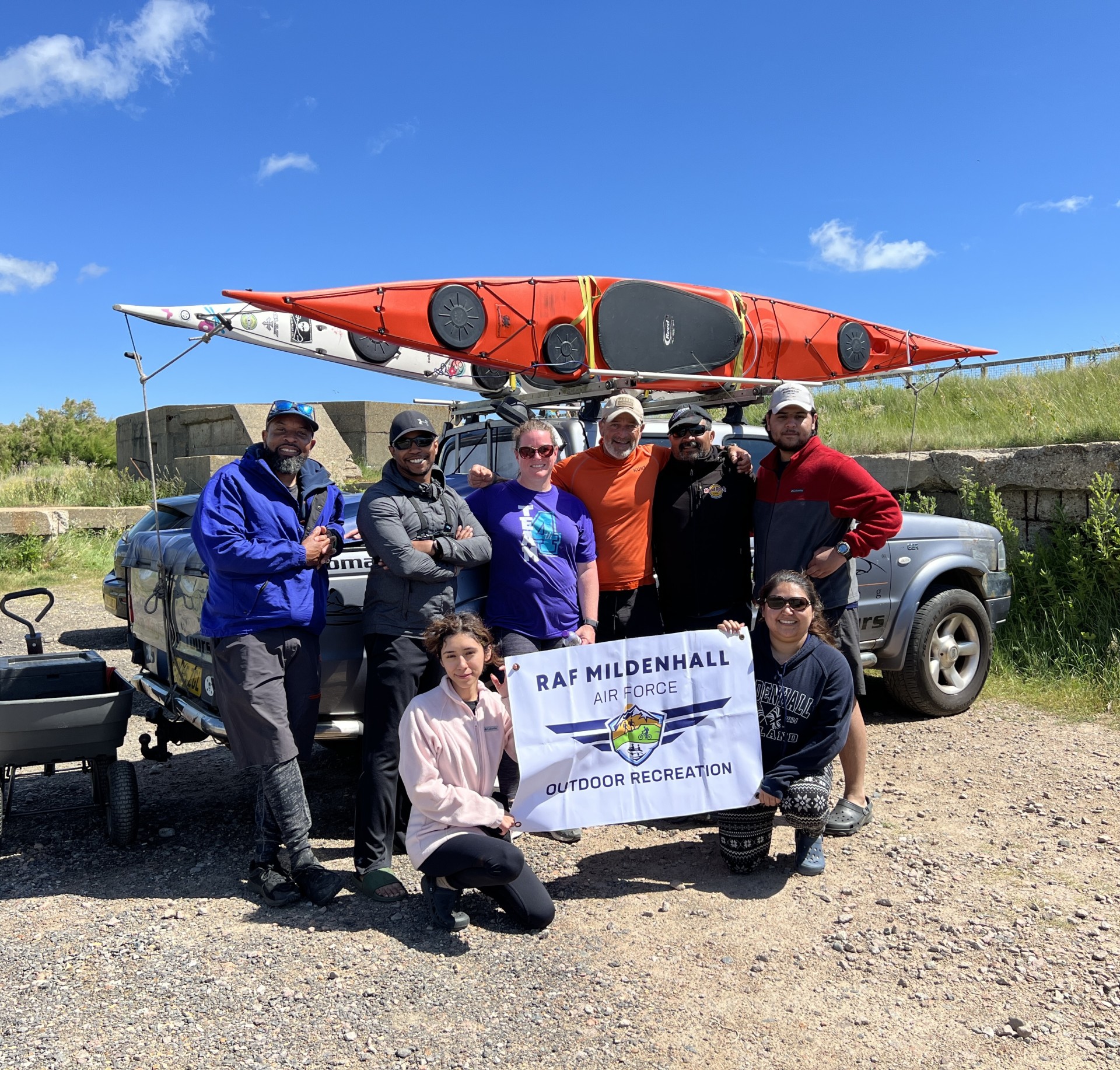 Group of paddlers posing for a groupie with NOMAD Sea Kayaking.