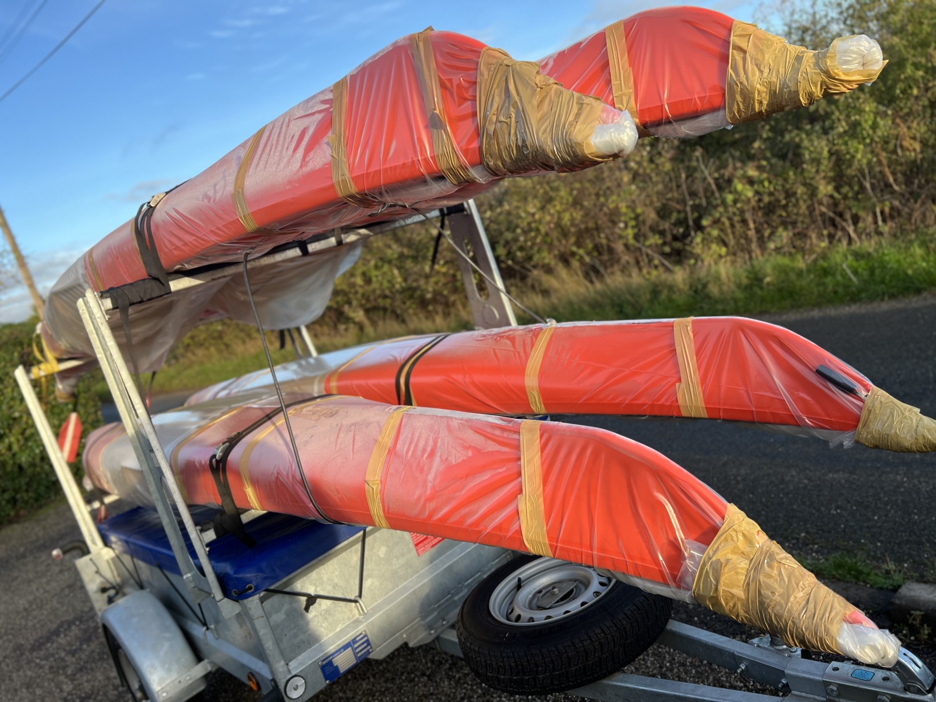 New sea kayaks in packaging on a trailer.