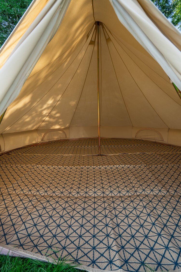 Interior view of 5m Bell tent on Hollyhocks Eco Retreat glamping site.