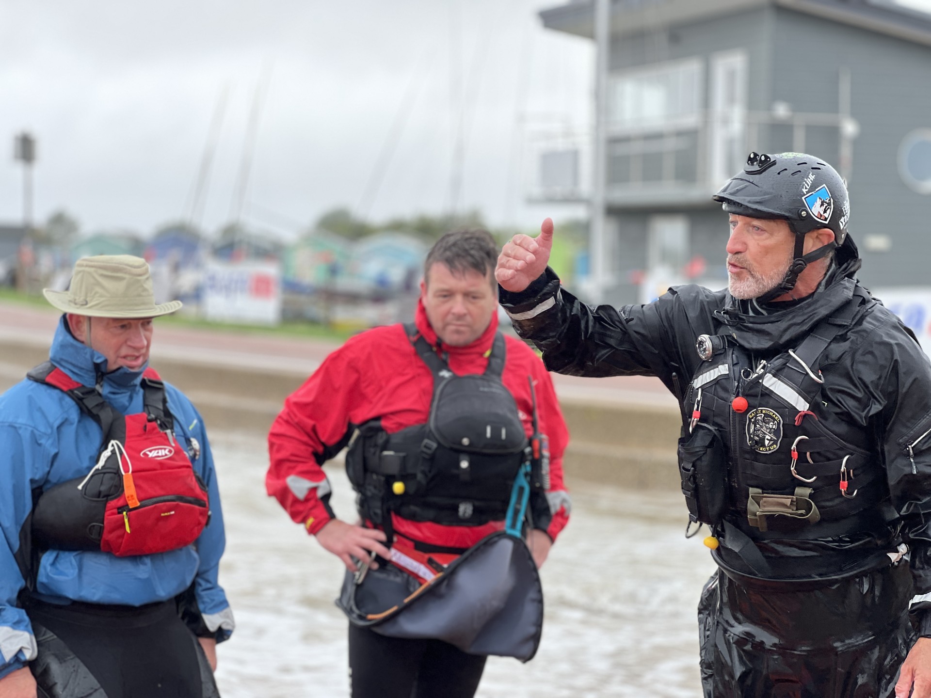 Coaching students in wet weather with NOMAD Sea Kayaking.