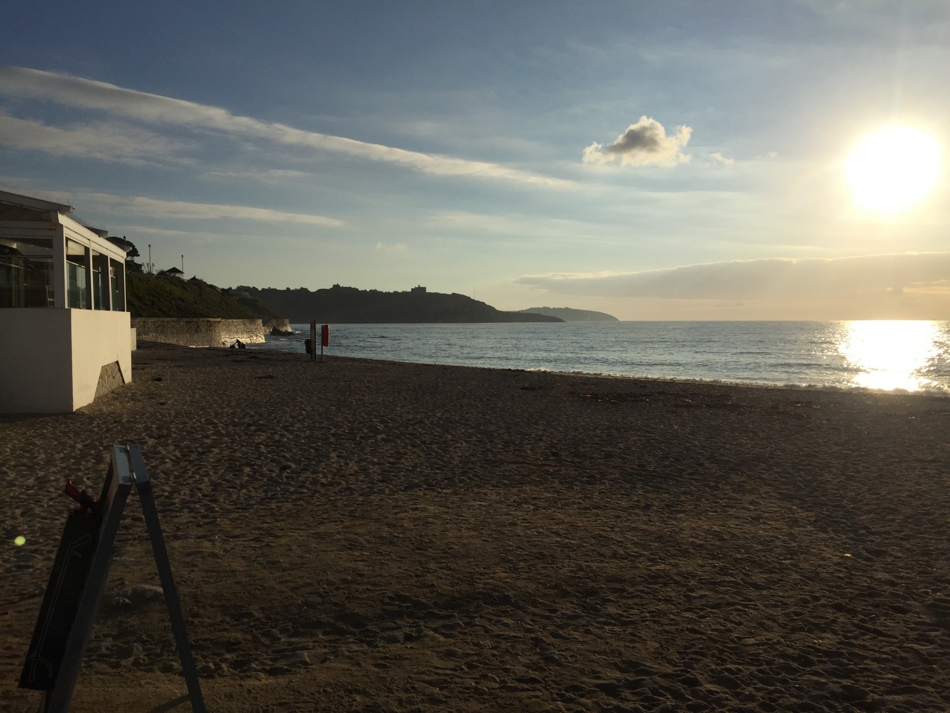 A sandy beach with an early morning sunrise