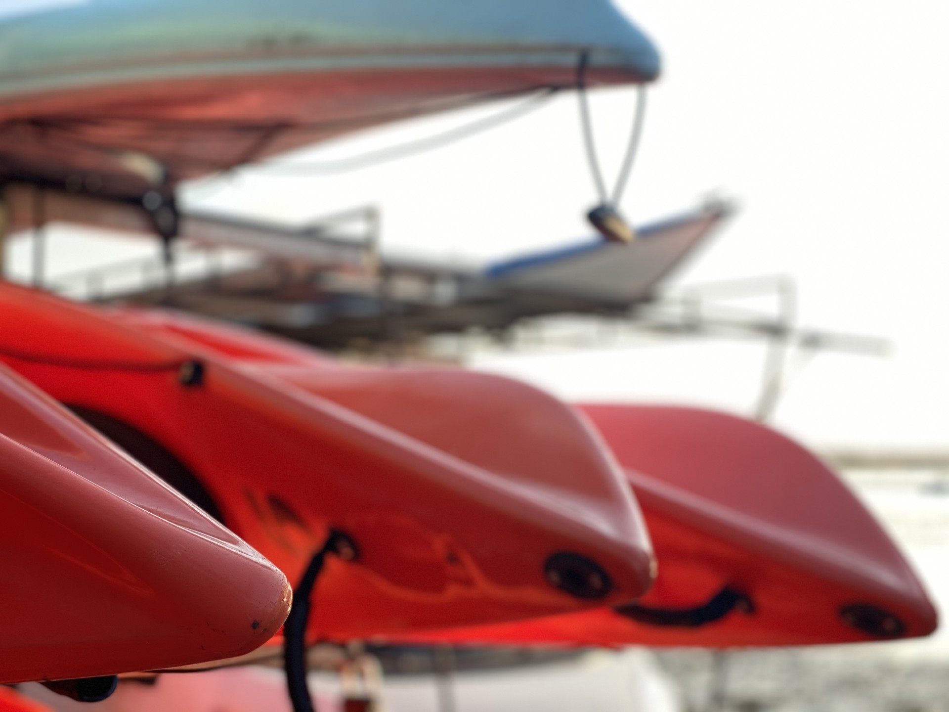 Orange sea kayaks loaded on a trailer.