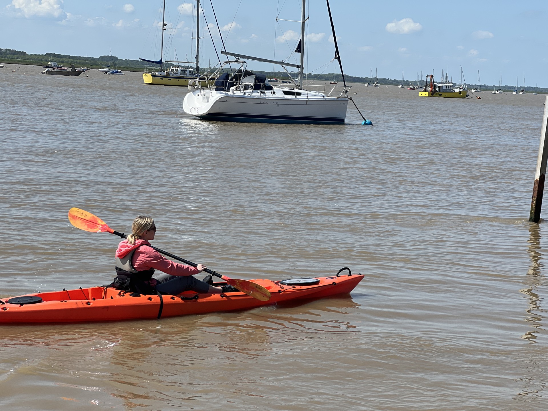 Sea kayaker paddling up the Deben estuary, Suffolk.