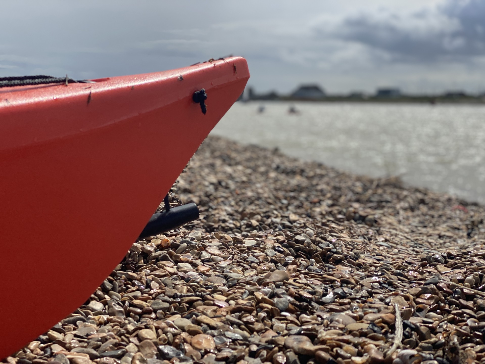 A shingle beach in Suffolk with NOMAD Sea Kayaking.