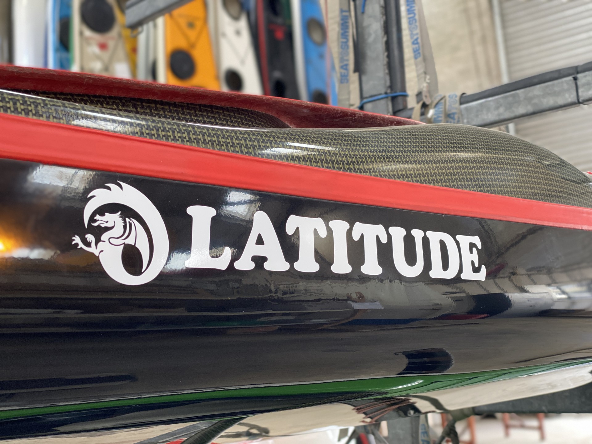 Latitude composite sea kayak with carbon composite deck and red trim