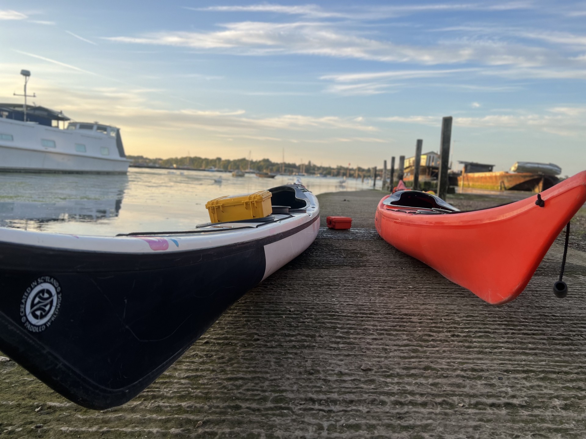 Sea kayaks on the slipway at Pin Mill with NOMAD Sea Kayaking.