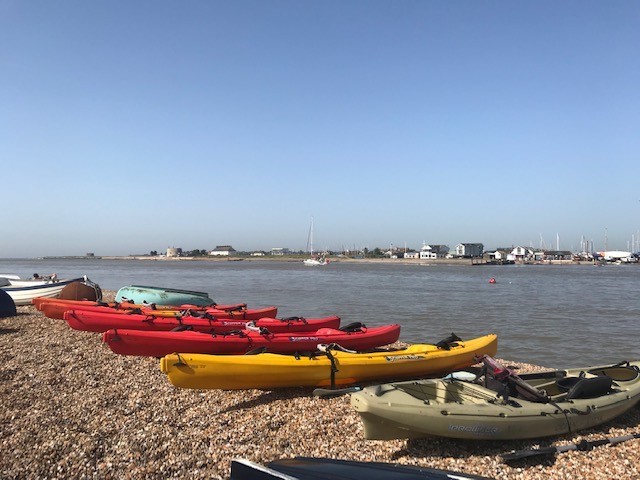 Deben estuary with Felixstowe Ferry under blue skies.