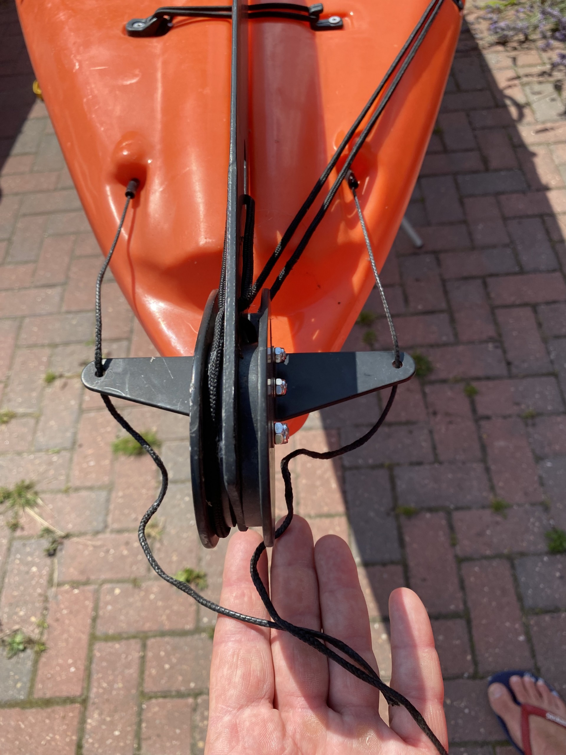 Sit-on-top kayak rudder showing untied steering cables.