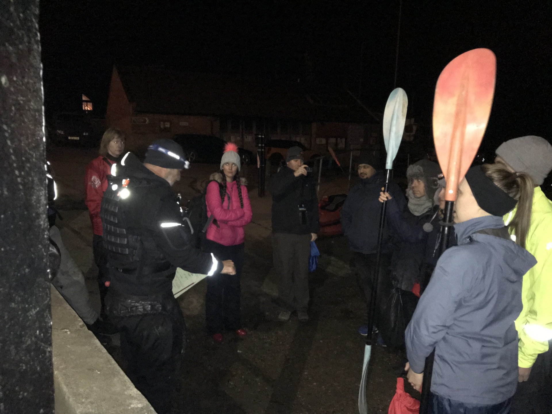 A guide doing the safety brief before a night kayak trip.