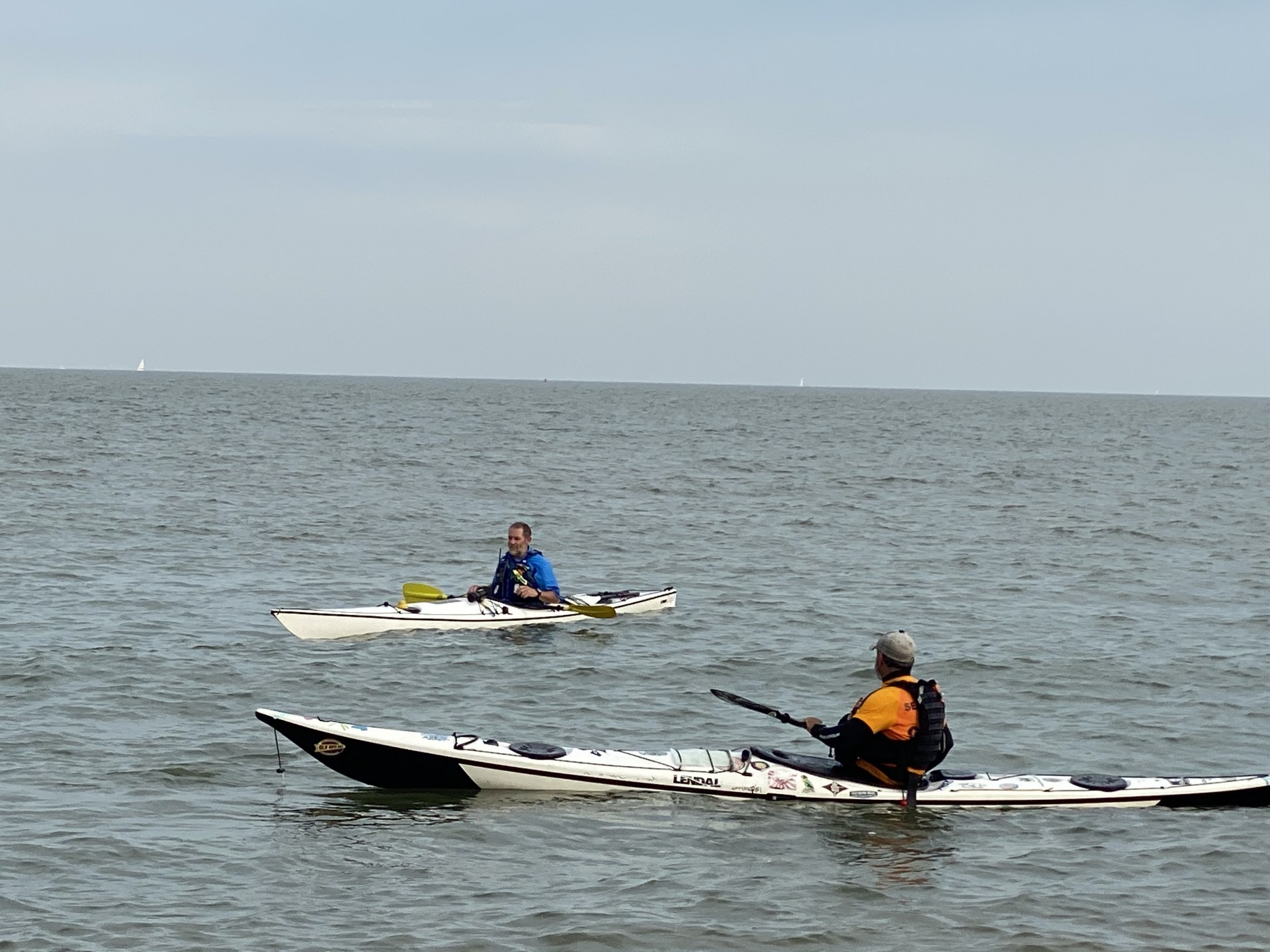 Two sea kayaks on the sea on a clear day