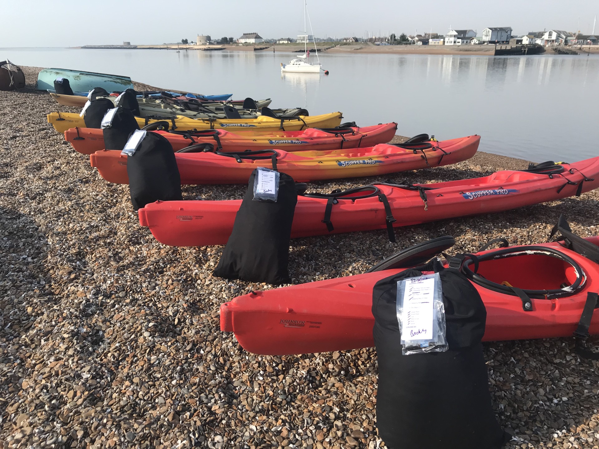 Sit-on-top kayaks ready to launch for the popular Suffolk weekend wild camp and kayaking event with NOMAD Sea Kayaking.