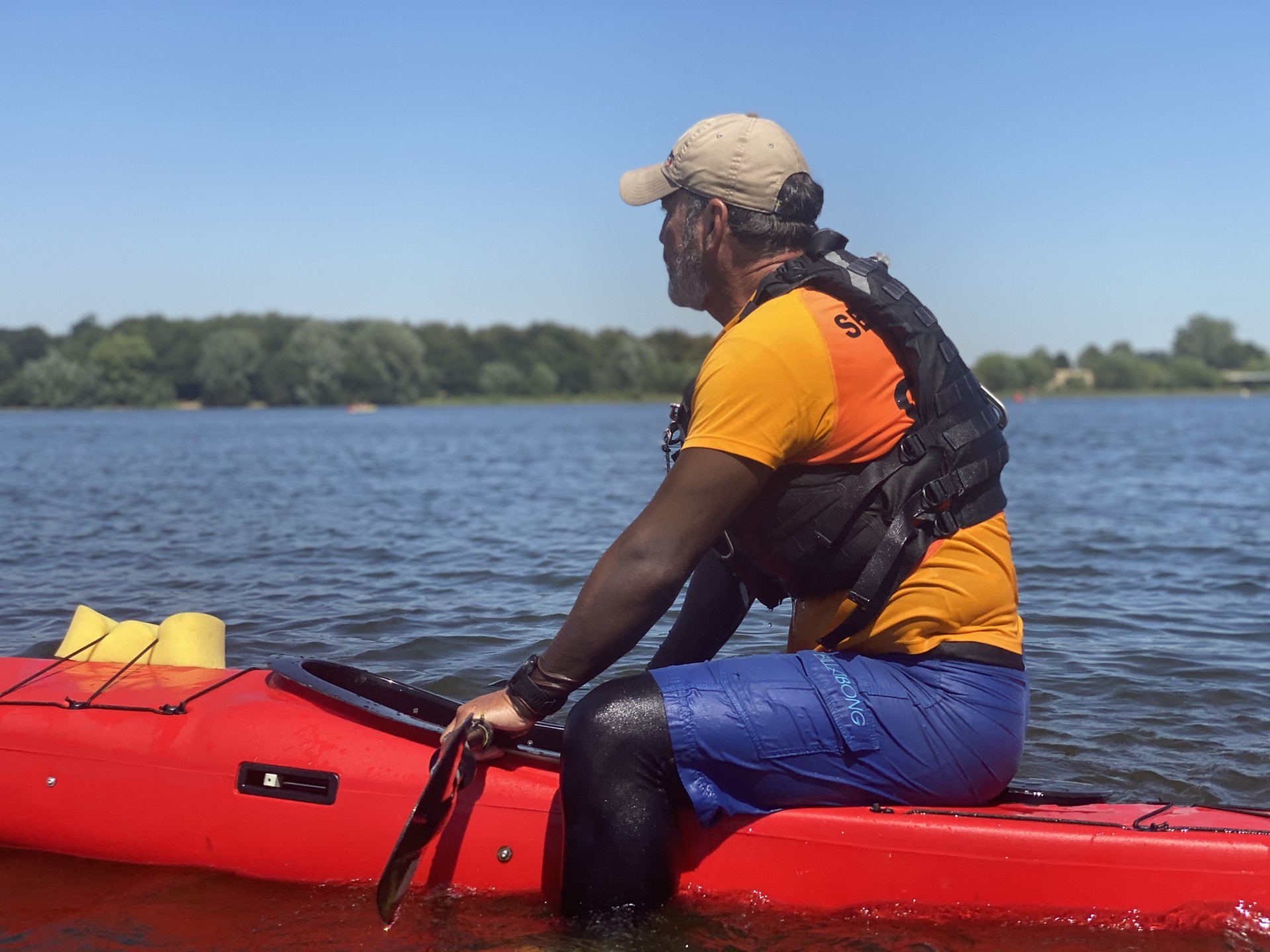 Stable NDK Sport RM sea kayak with a paddler sitting on the back deck