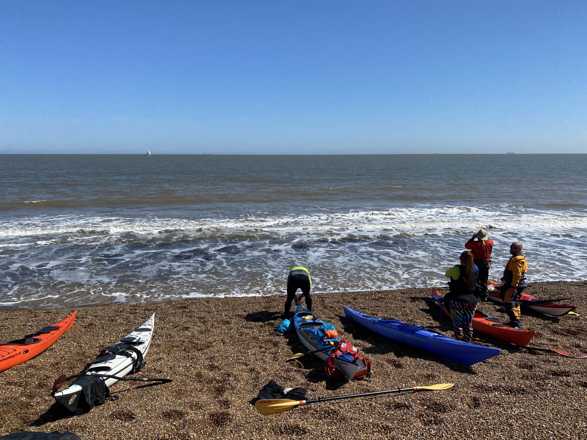 Sea kayakers preparing to launch on the Suffolk coast.