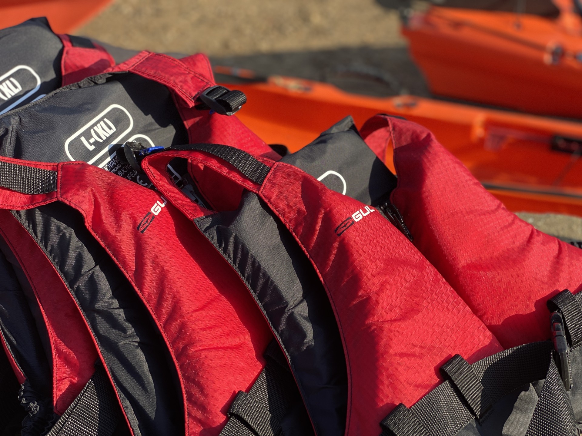 Red buoyancy aids neatly stacked ready for use.