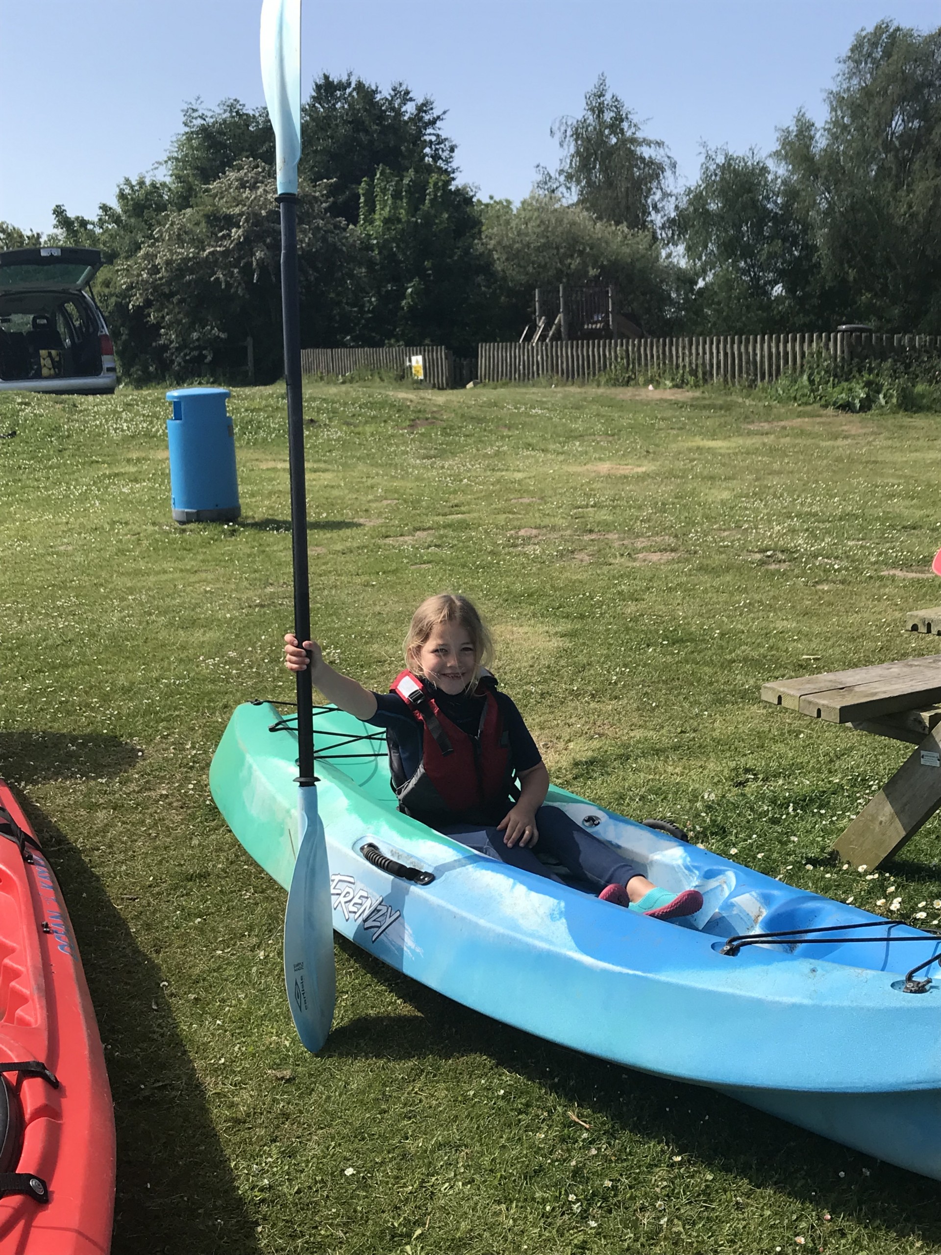 A little girl sitting iun a kayak for the family fun kayaking taster session