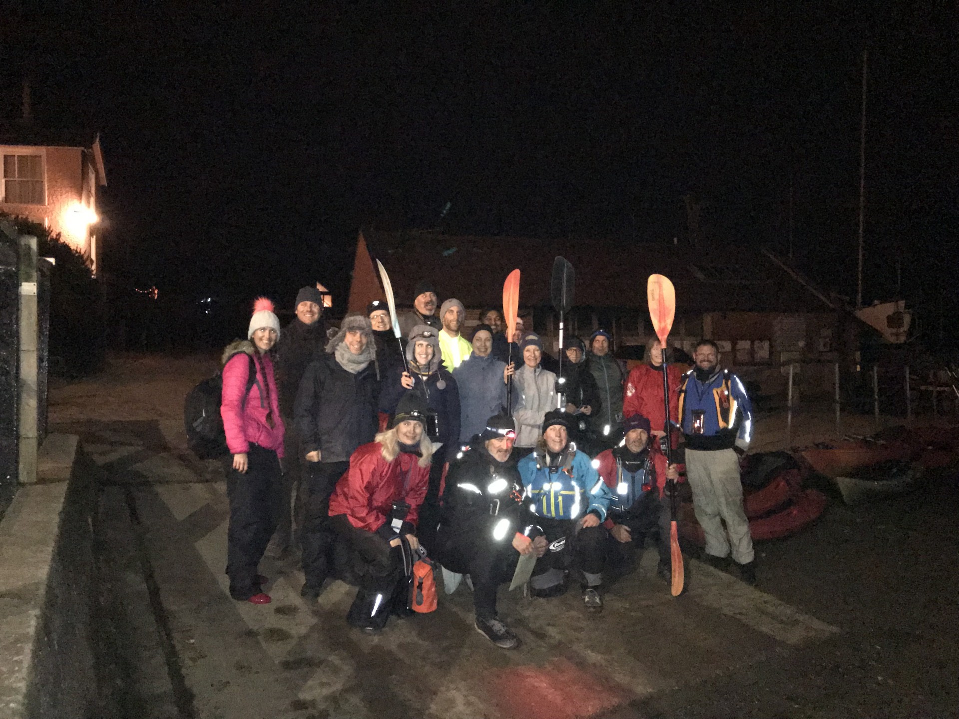 Group of paddlers posing for the camera before the new years eve fireworks by kayak trip with NOMAD Sea Kayaking.