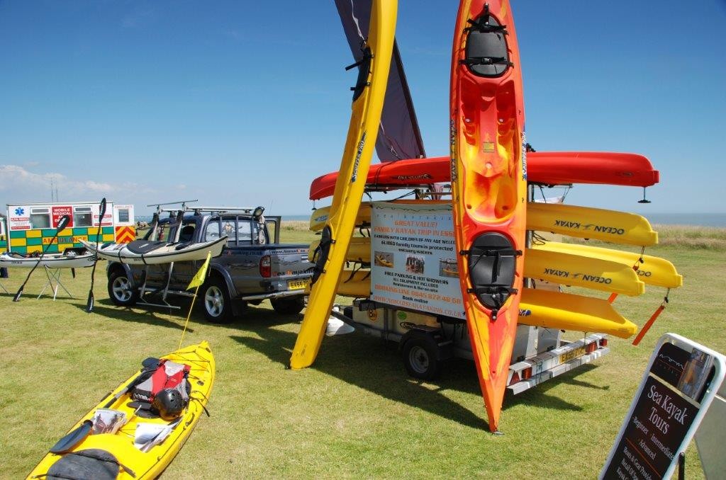 A selection of sea kayaks on display with NOMAD Sea Kayaking.