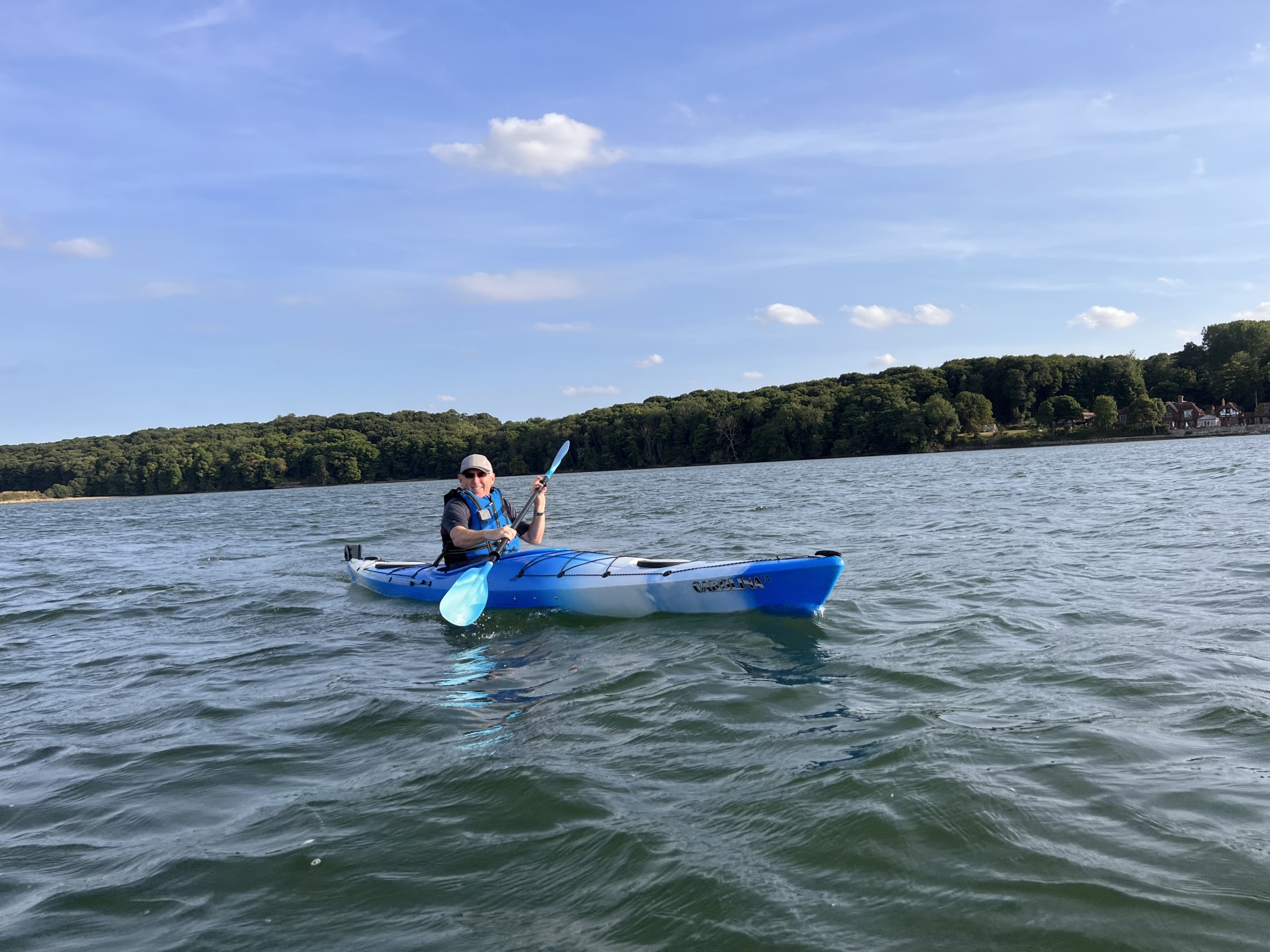 A sea kayaker paddling the beautiful Orwell estuary in a touring kayak.