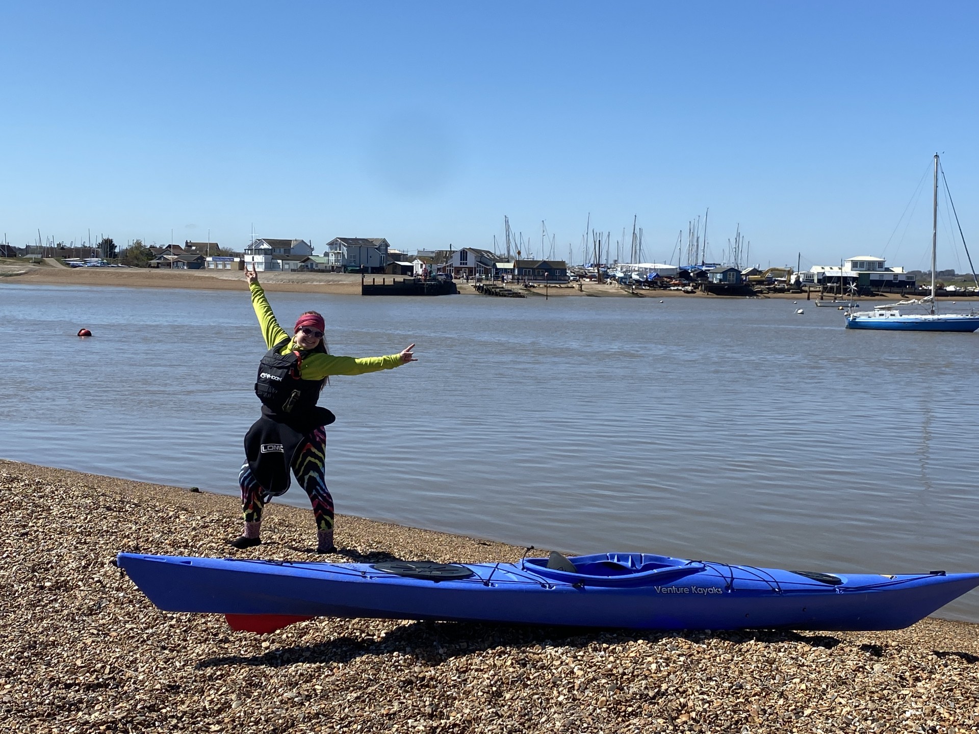 /storage/This Girl Can, female sea kayaker on the beach with her sea kayak.