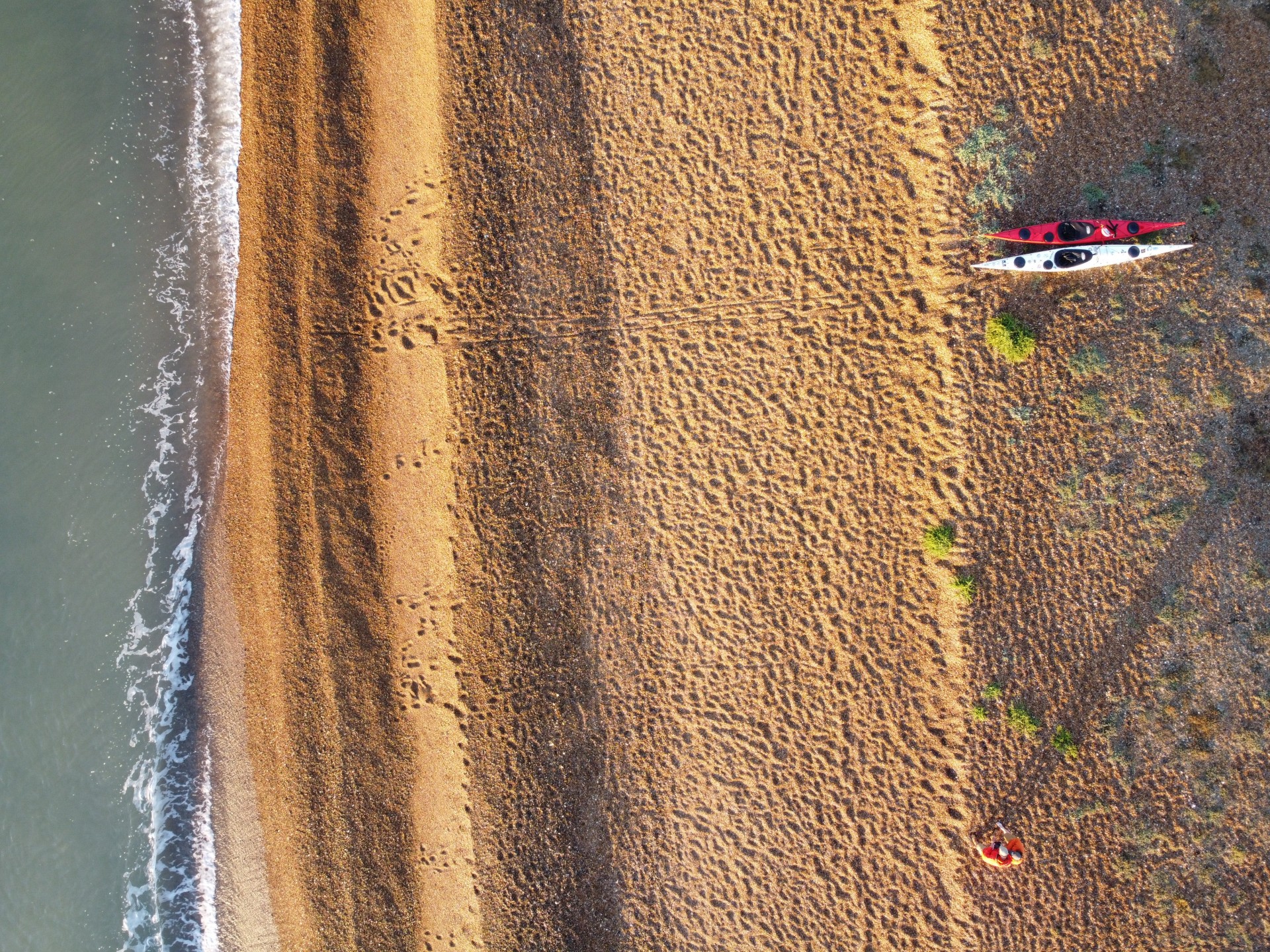 /storage/Aerial view of a beach with two kayaks on it