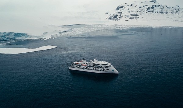 Greg Mortimer ship in polar region guided kayaking with NOMAD Sea Kayaking.