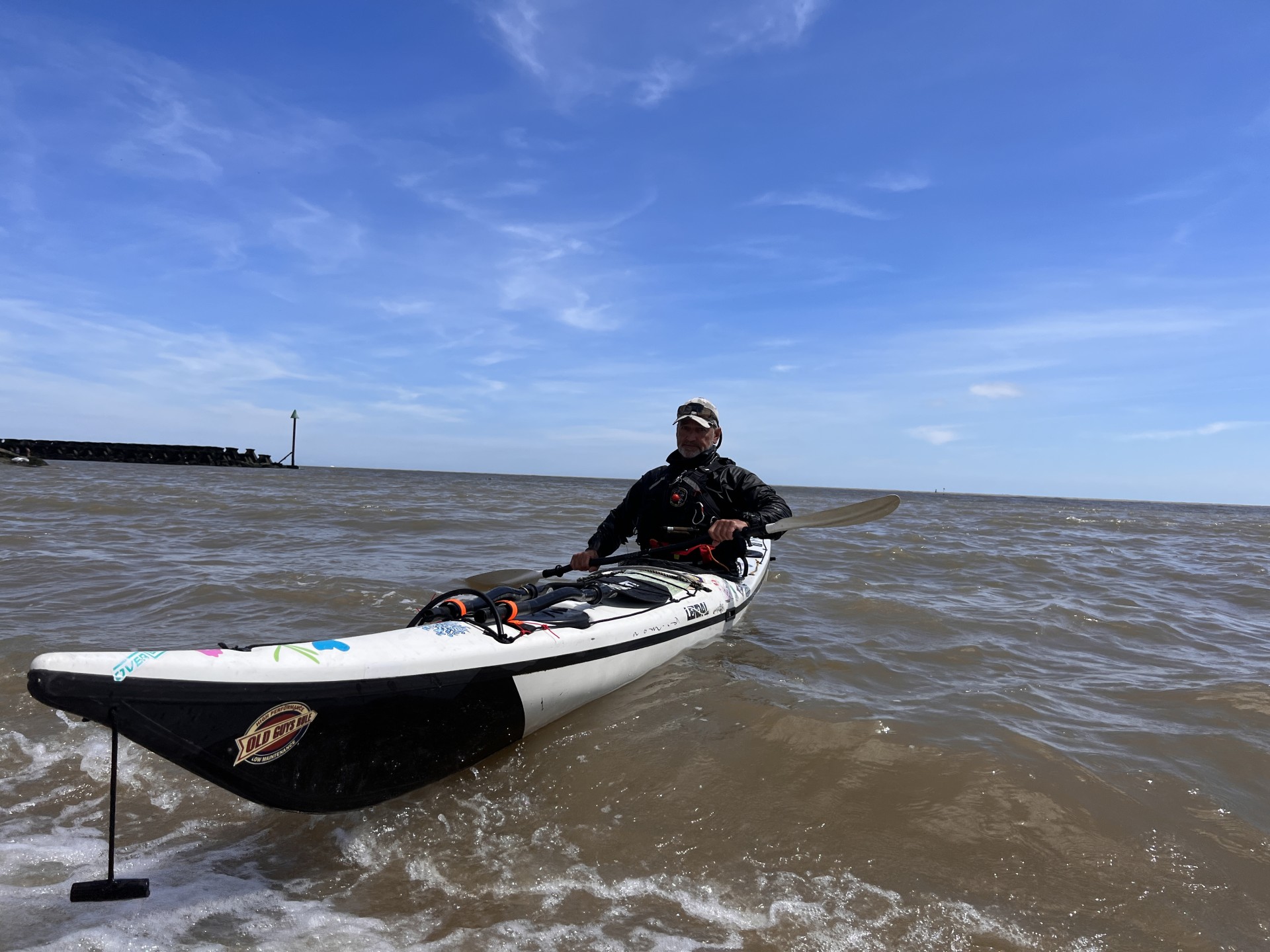 A paddler in a white & black NDK Explorer composite sea kayak.
