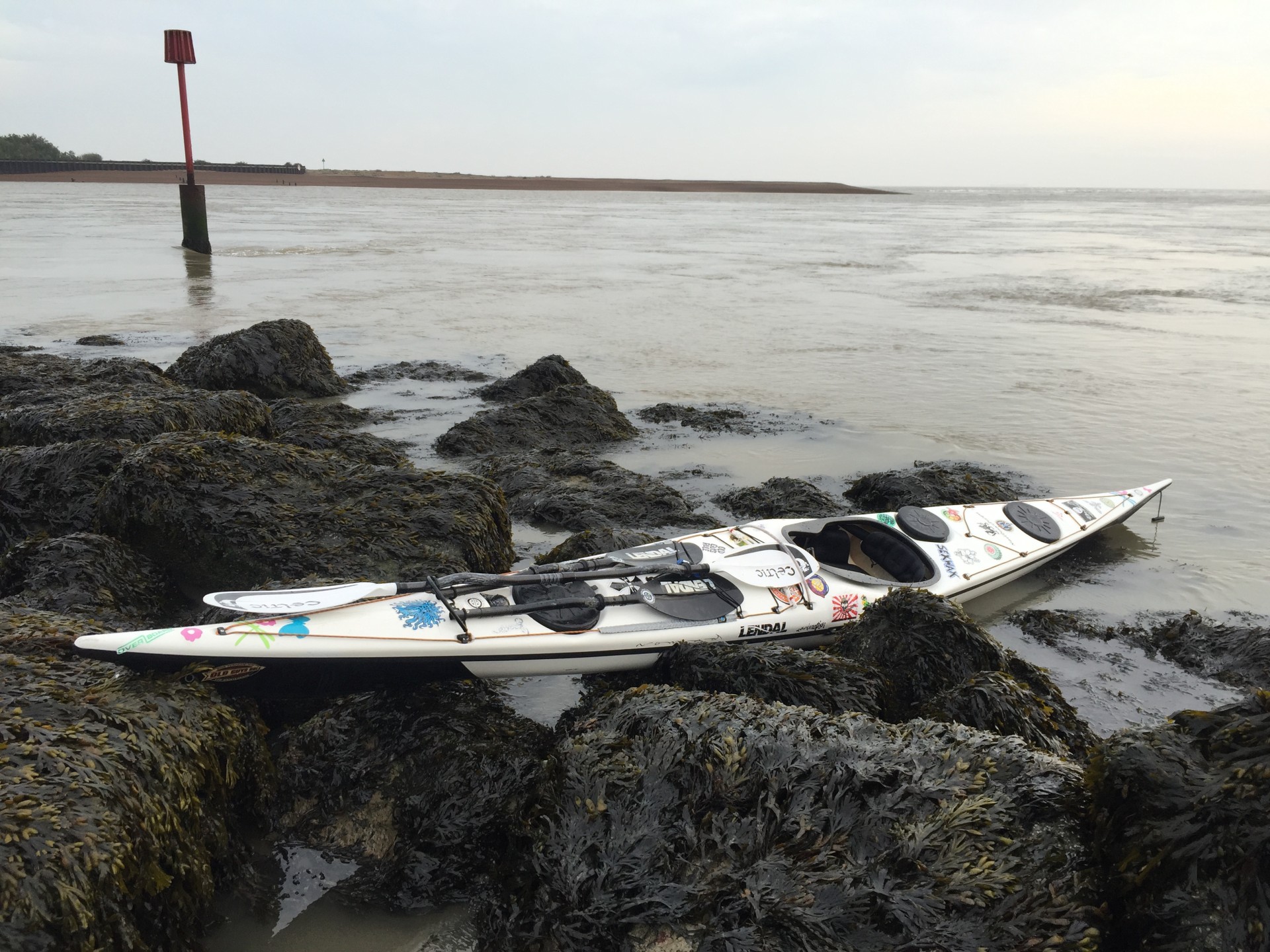 Expedition sea kayak with strong flowing water in background.