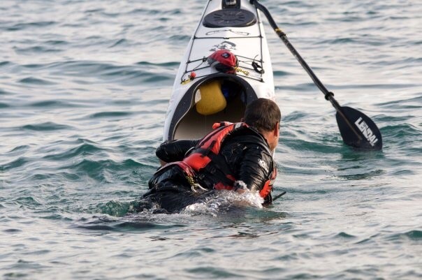 A sea kayaker doing a deep water self recovery in Suffolk, East Anglia.