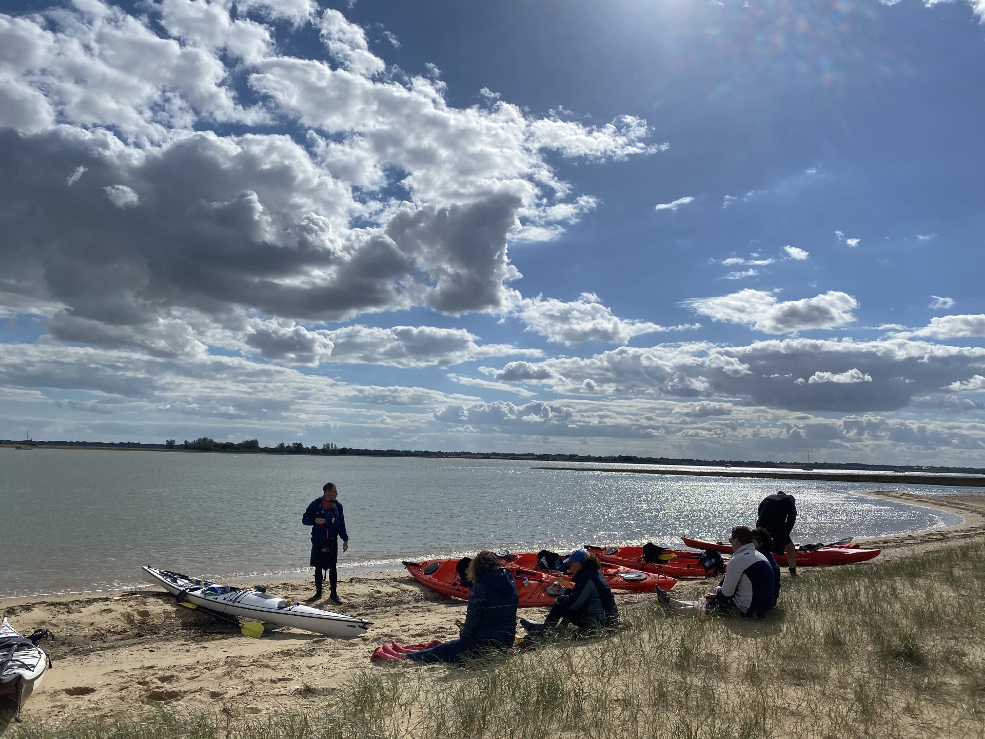 Sea kayakers taking a winter break on a sandy beach.