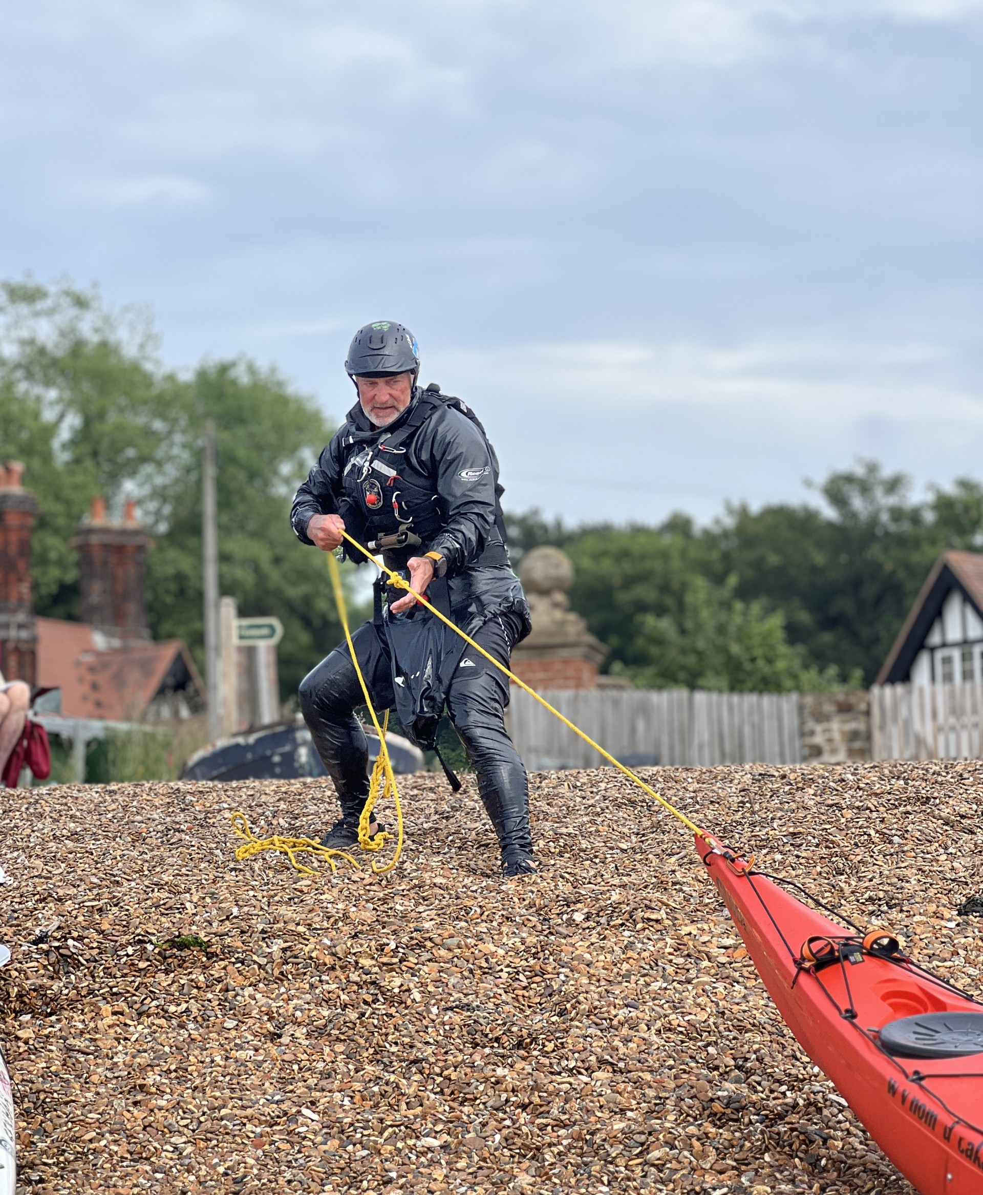 Coach retrieving his tow line with NOMAD Sea Kayaking.